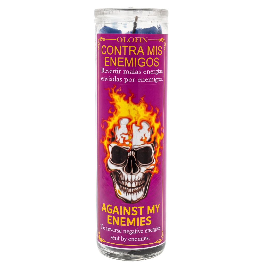 A tall glass jar candle with a purple label featuring a skull with flames for hair, with the text 'OLOFIN CONTRA MIS ENEMIGOS' and 'AGAINST MY ENEMIES'.