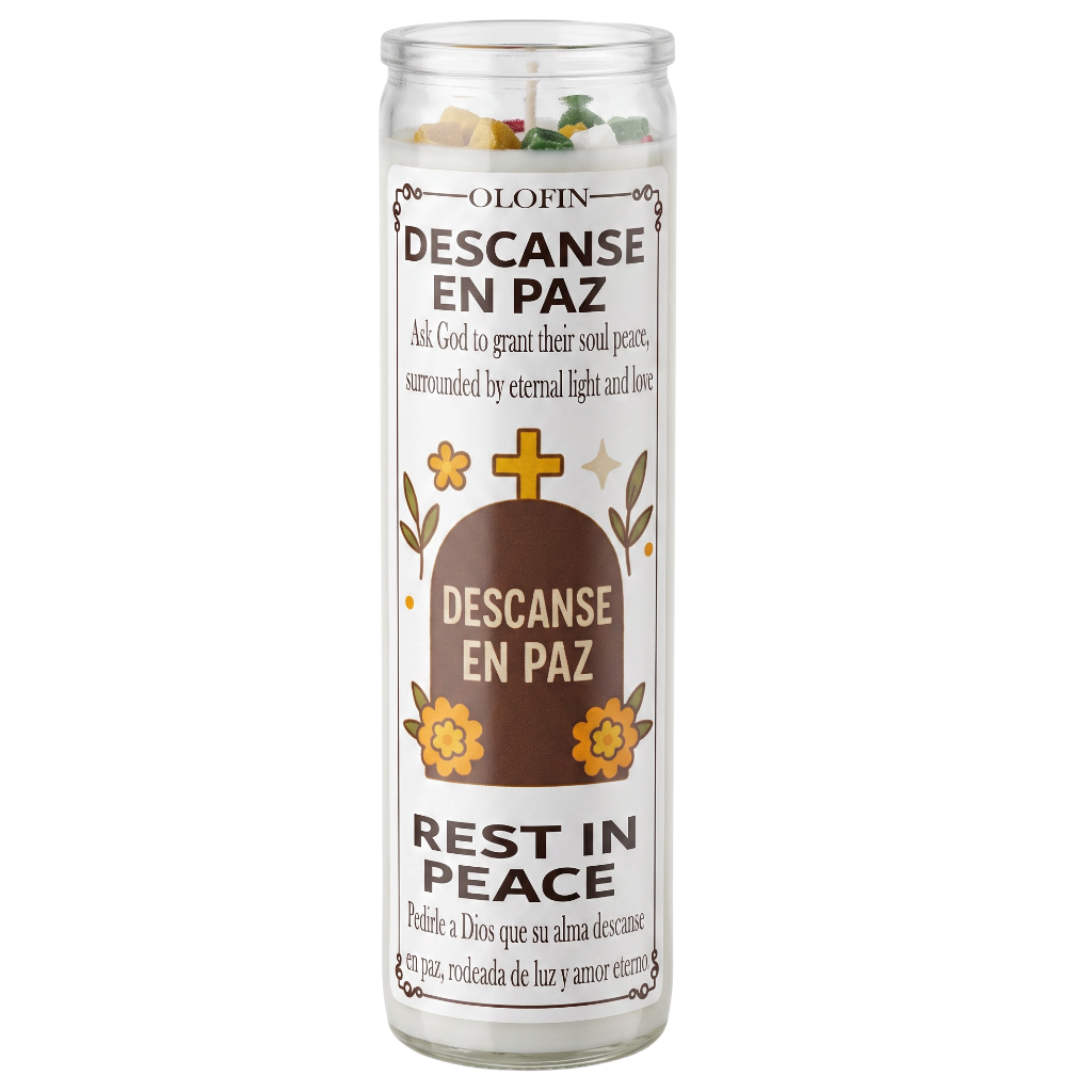 A tall glass jar candle with a white label reading 'Olofin Descanse En Paz' and 'Rest in Peace,' featuring a tombstone graphic, flowers, and small colorful wax pieces visible at the top.