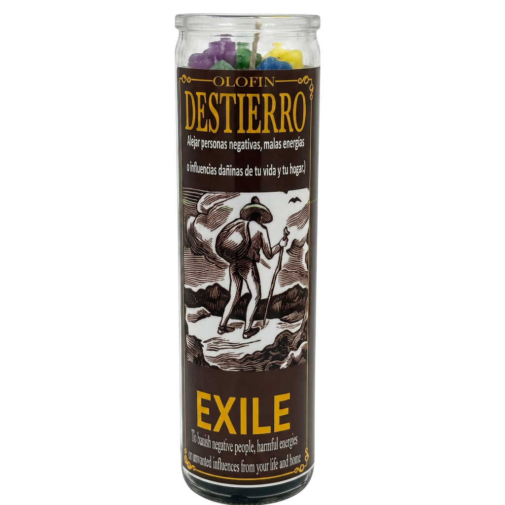 A tall glass jar candle labeled 'Olofin Destierro Exile' with a dark brown label, yellow text, and an illustration of a person standing on rocks. Multicolored wax pieces are visible at the top through the clear glass, on a white background.