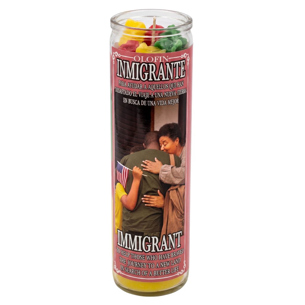 A tall glass jar candle labeled 'Olofin Immigrante' with a printed label showing two embracing people and the word 'IMMIGRANT' in large letters. The candle contains multicolored wax pieces visible at the top, and the glass jar sits on a plain white background.