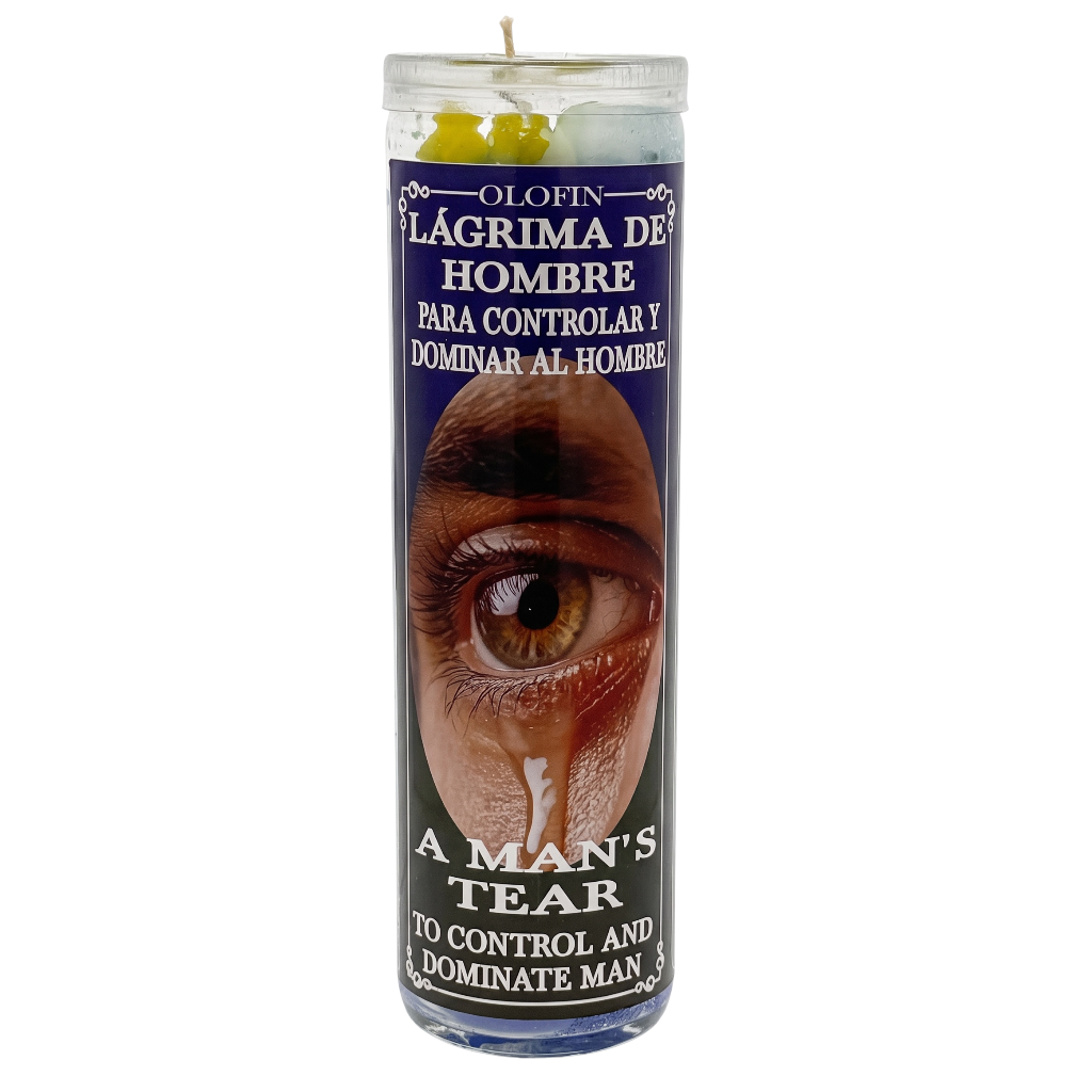 A tall glass jar candle with a white wick and white wax, featuring a dark blue label with Spanish text reading 'OLOFIN LÁGRIMA DE HOMBRE' and English text 'A MAN'S TEAR'. The label includes a close-up photo of a crying human eye and small yellow flower illustrations near the top.