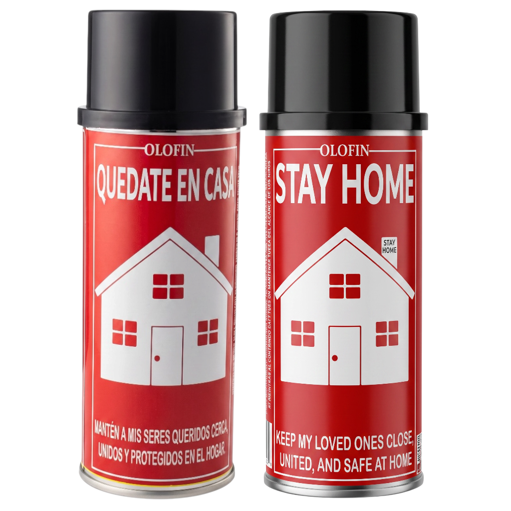 Two Olofin Stay Home aerosol cans with red labels and black caps, featuring a white house graphic and Spanish and English text, on a white background.