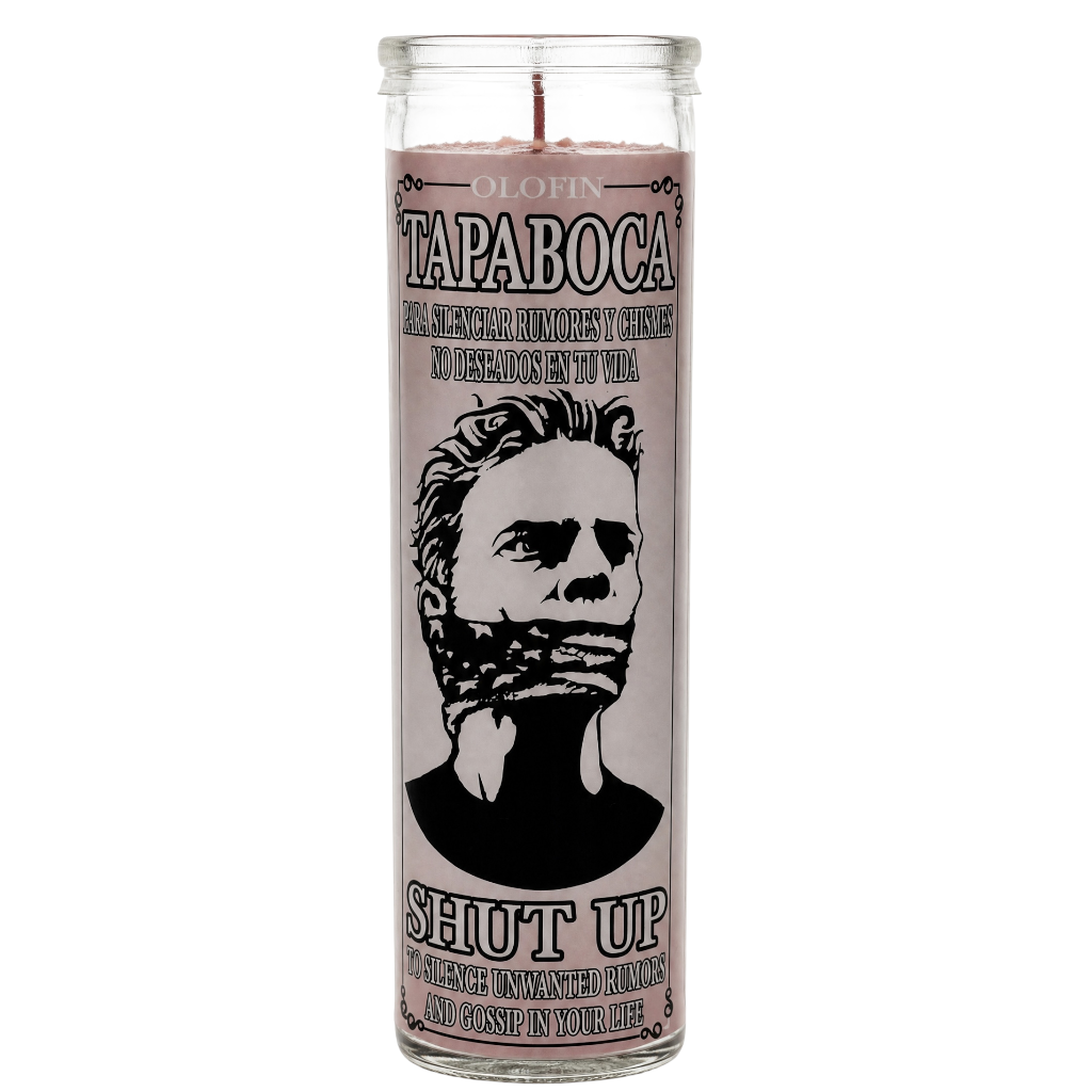 A tall glass jar candle with a pale pink label featuring a black-and-white illustrated portrait and the text 'OLAFIN TAPABOCA' and 'SHUT UP'.