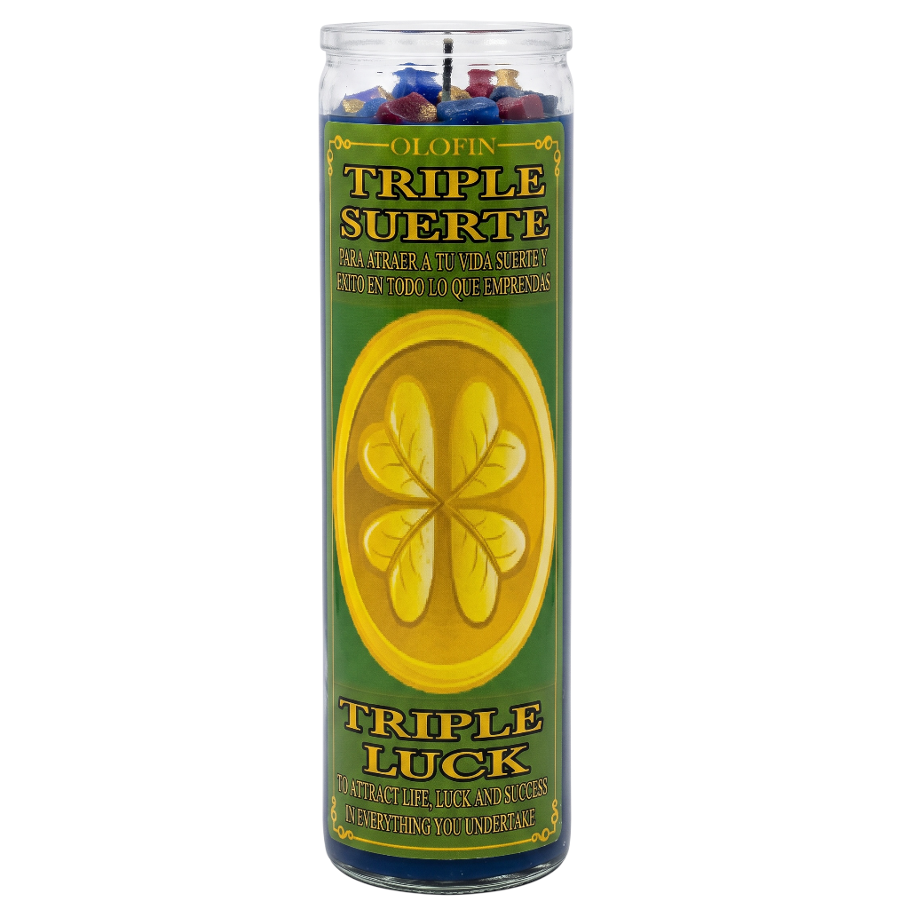 A tall glass jar candle labeled 'Olofin Triple Suerte Triple Luck' with a green label, yellow shamrock design, and multicolored wax pieces visible at the top, shown on a plain white background.