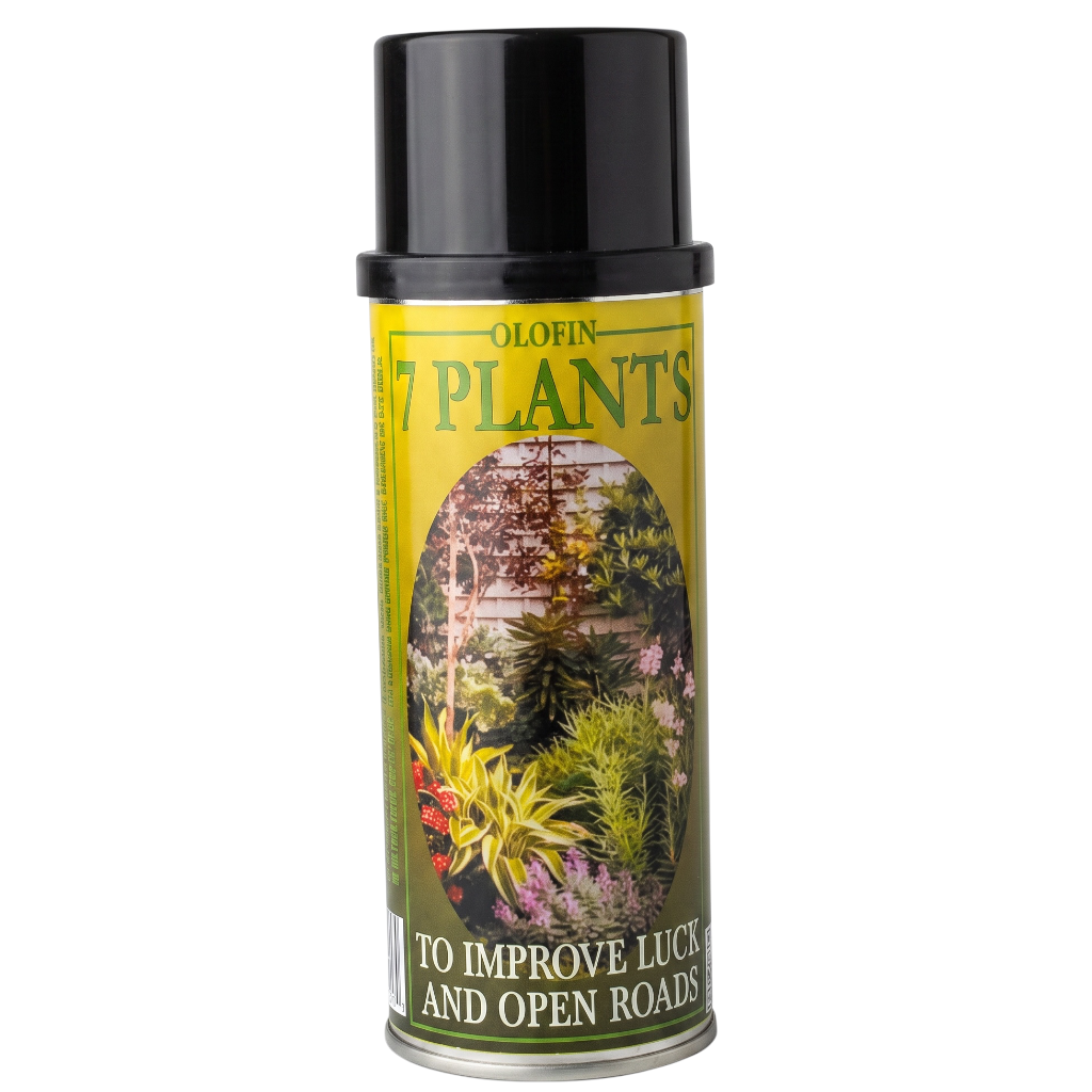 A can of Olofin 7 Plants spray with a black cap and a yellow-green label featuring an illustration of a garden and text that reads 'To Improve Luck and Open Roads'.