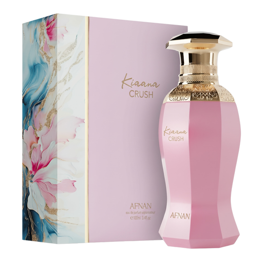 Pink perfume bottle with gold cap and floral packaging on a white background