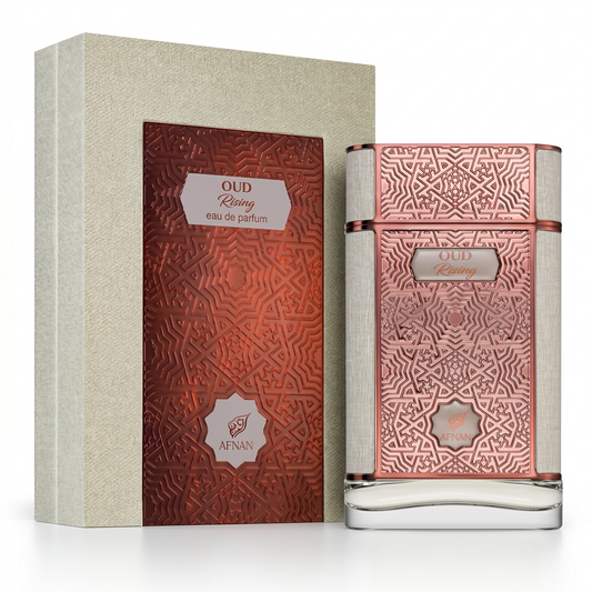 Perfume bottle and packaging with intricate designs on a white background