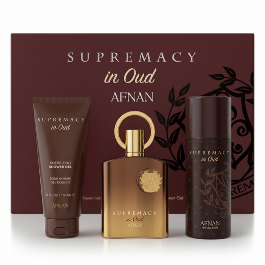 Afnan Supremacy in Oud fragrance set with shower gel, perfume, and deodorant against a maroon background.