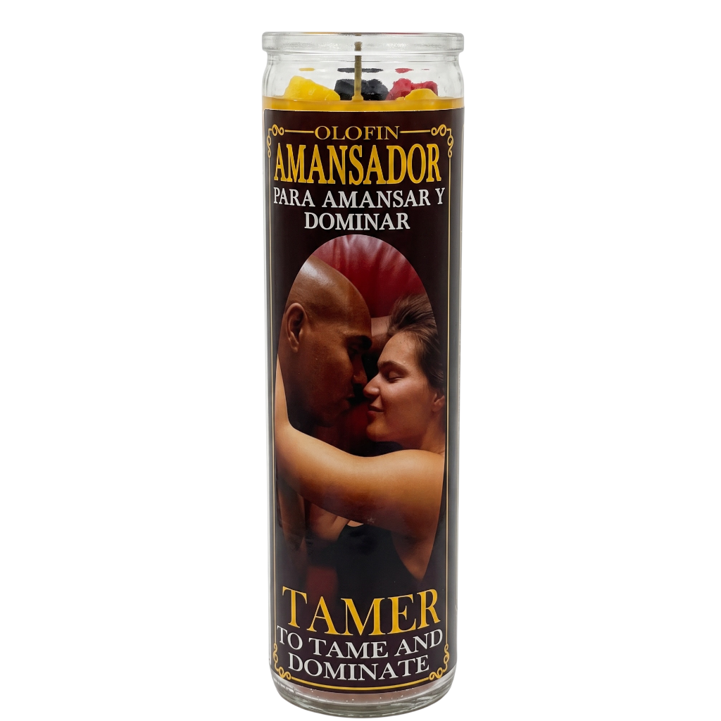 A tall glass jar candle with a printed label featuring a couple embracing, Spanish text reading 'Olofin Amansador Para Amansar Y Dominar,' and English text reading 'Tamer To Tame And Dominate,' on a plain white background.