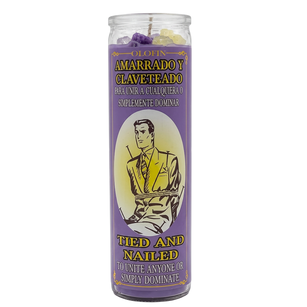 A tall glass jar candle with a purple label reading 'Olofin Amarrado y Claveteado' and 'Tied and Nailed' in yellow text, featuring an illustration of a man in a suit. The candle contains purple, white, and yellow wax pieces visible at the top.