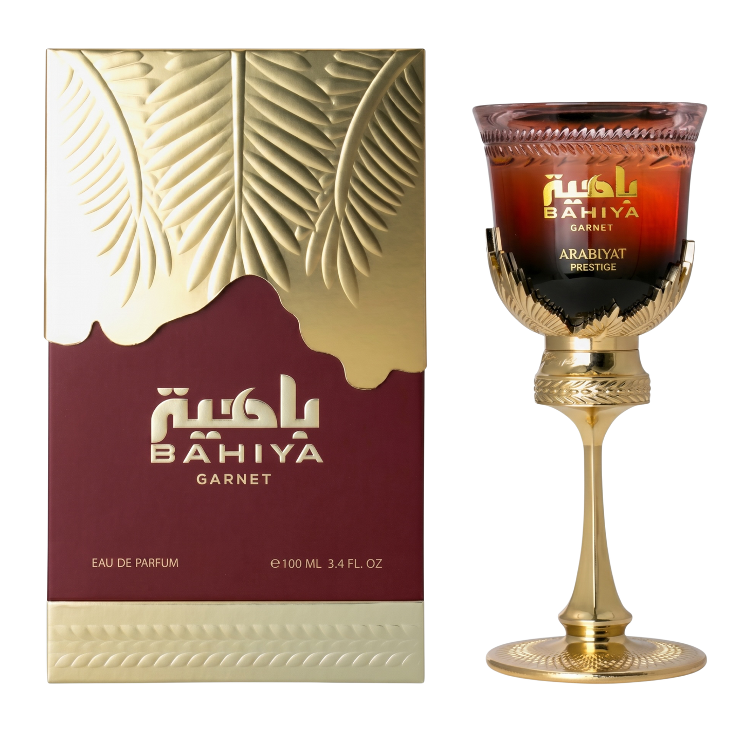 Bahiya Garnet perfume packaging and a decorative glass with gold accents.