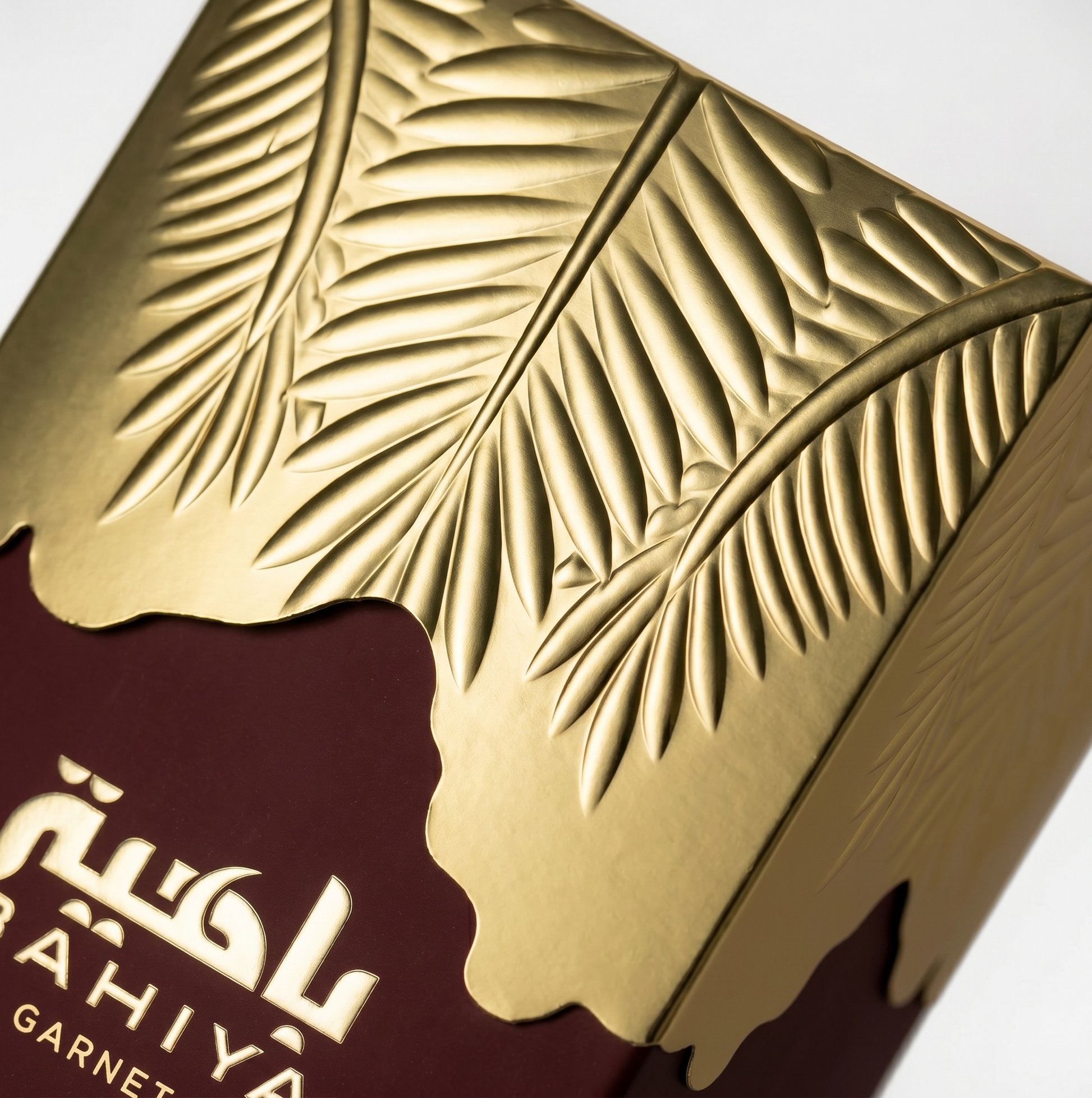 Close-up of a gold and brown product packaging with leaf patterns