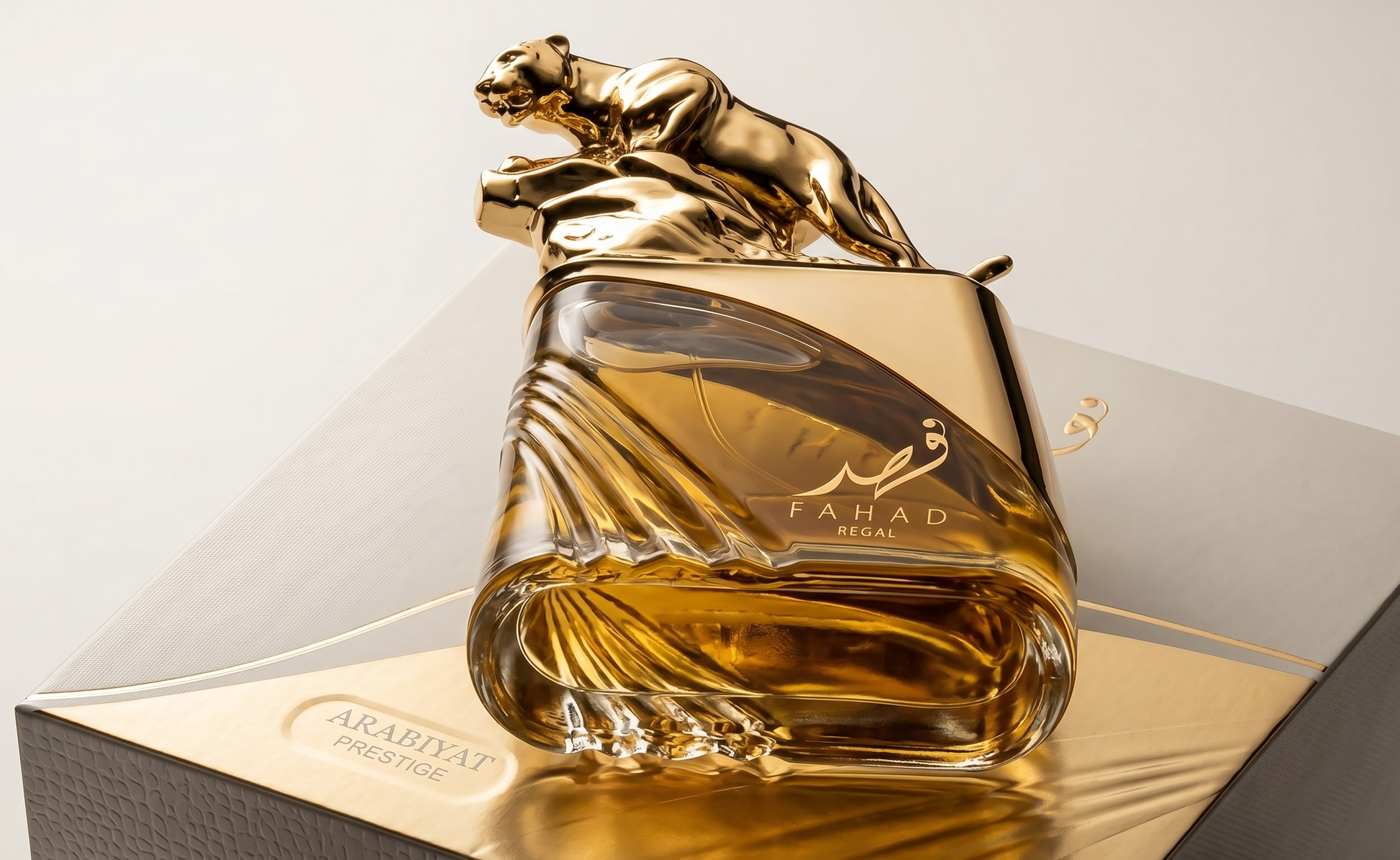 Gold and glass perfume bottle with panther design on a white background