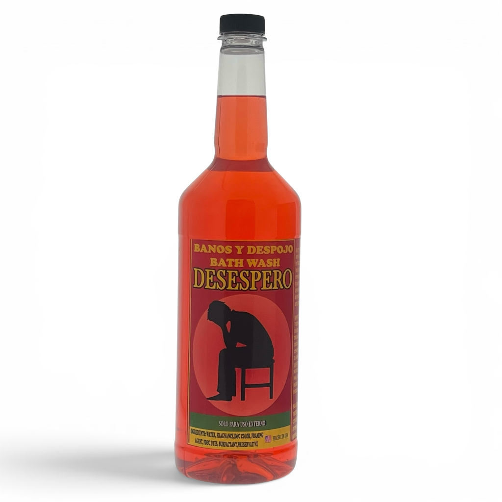 A bottle of red bath wash with a black cap and a red label featuring a black silhouette of a person sitting on a chair. The label reads 'BANOS Y DESFOY BATH WASH DESESPERO'.