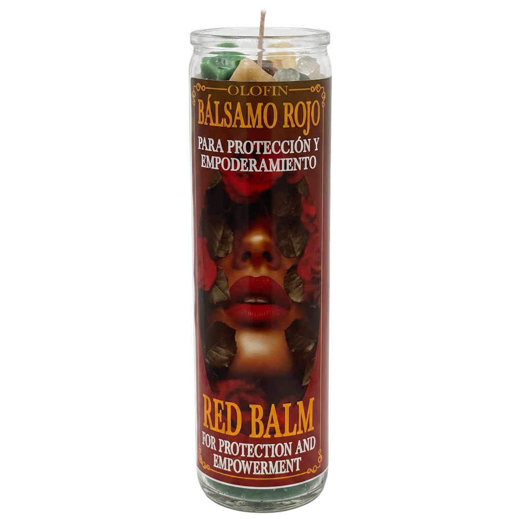 A tall glass prayer candle labeled 'Olofin Balsamo Rojo' with a red and black graphic of a woman's face, featuring multicolored wax visible at the top.
