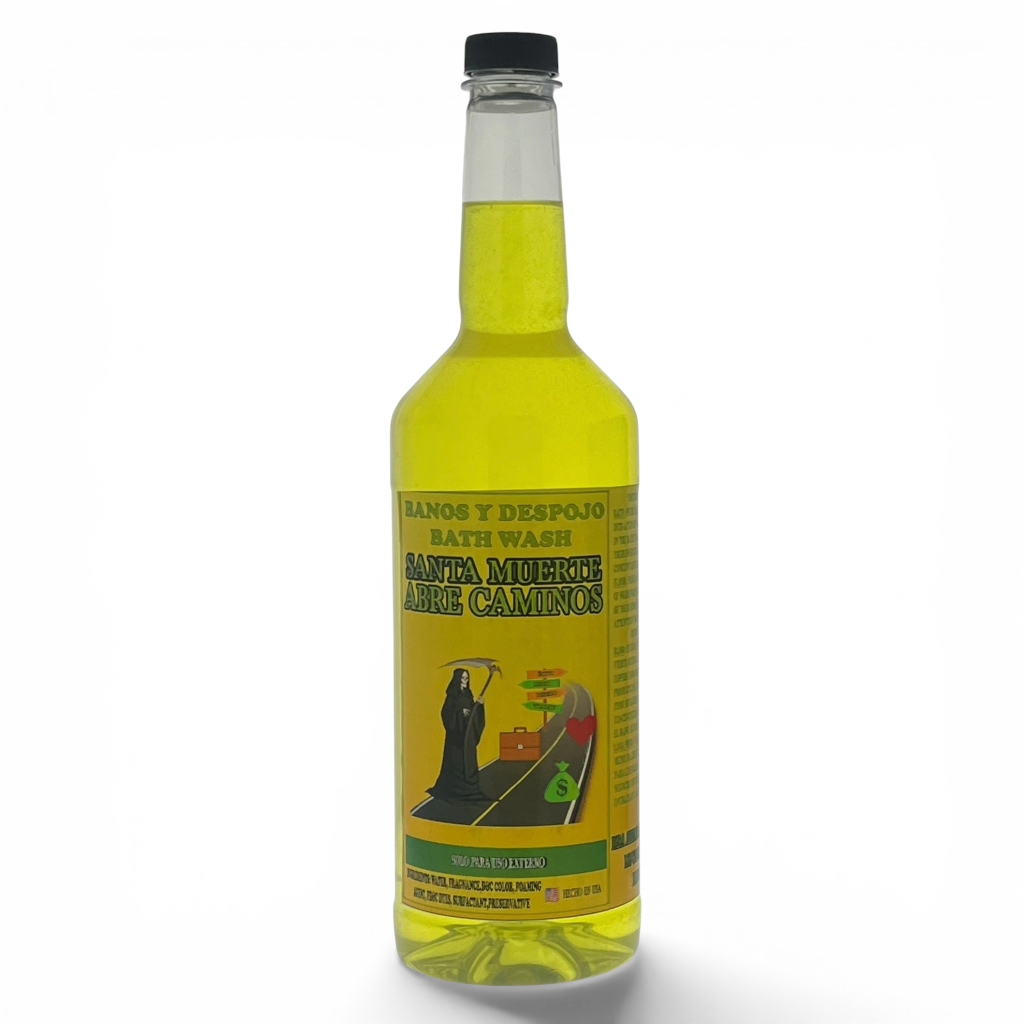 A clear glass bottle of Santa Muerte Arre Camino bath wash filled with yellow liquid, featuring a black cap and a yellow label with a grim reaper illustration, set against a plain white background.