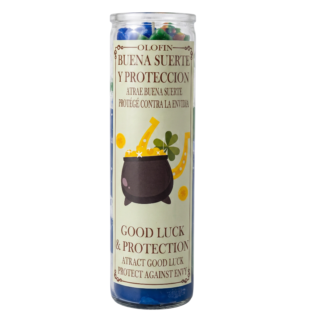 A tall glass jar candle with a clear lid and a cream-colored label featuring a cauldron, horseshoe, and clover illustration. The label reads 'Olofin Buena Suerte Y Proteccion' and 'Good Luck & Protection'.