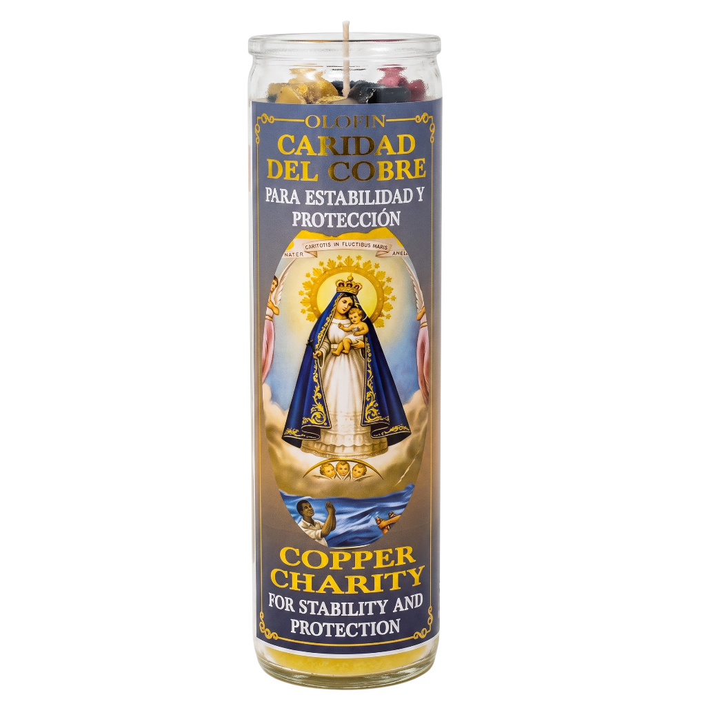 A tall glass prayer candle with a copper-colored label featuring a religious illustration of Our Lady of Mount Carmel and Spanish and English text reading 'Caridad del Cobre' and 'Copper Charity for Stability and Protection.'.