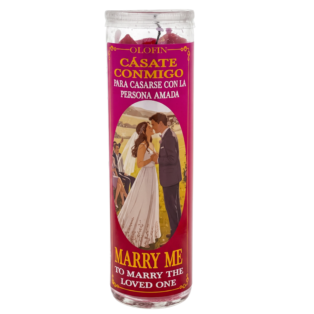 A tall glass jar candle with a bright pink label featuring a vintage-style illustration of a bride and groom kissing, with Spanish text reading 'Olofin Casate Conmigo' and English text reading 'Marry Me To Marry The Loved One'.