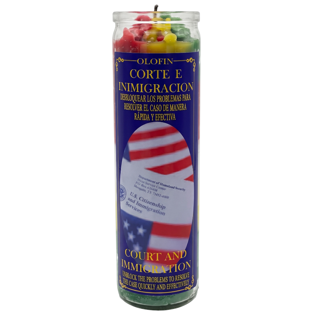 A tall glass prayer candle with a blue label reading 'Olofin Corte e Inmigracion' and 'Court and Immigration,' featuring an American flag graphic and multicolored wax pieces visible at the top.