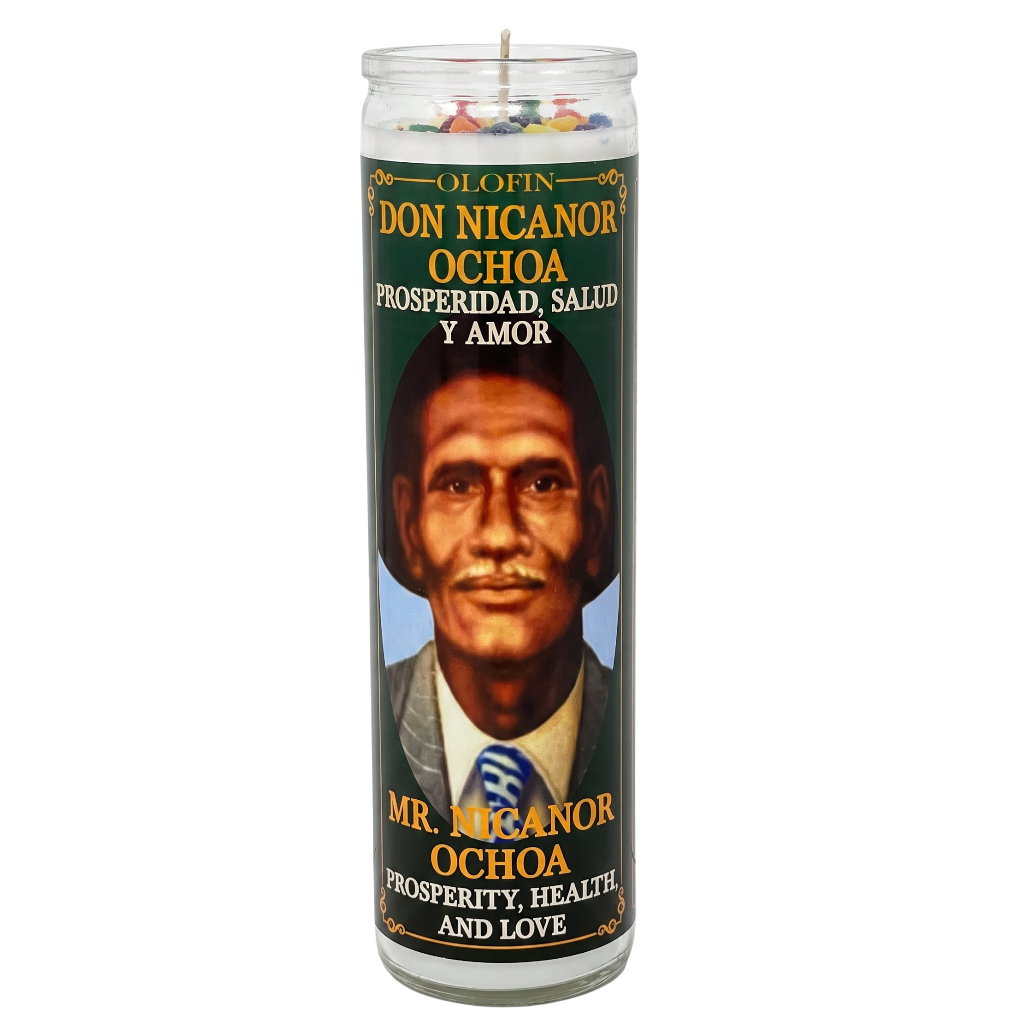 A tall glass prayer candle with a printed label featuring a portrait of Don Nicanor Ochoa. The label has a dark green background with gold and white text reading 'Olofin Don Nicanor Ochoa Prosperidad, Salud Y Amor' and 'Mr.