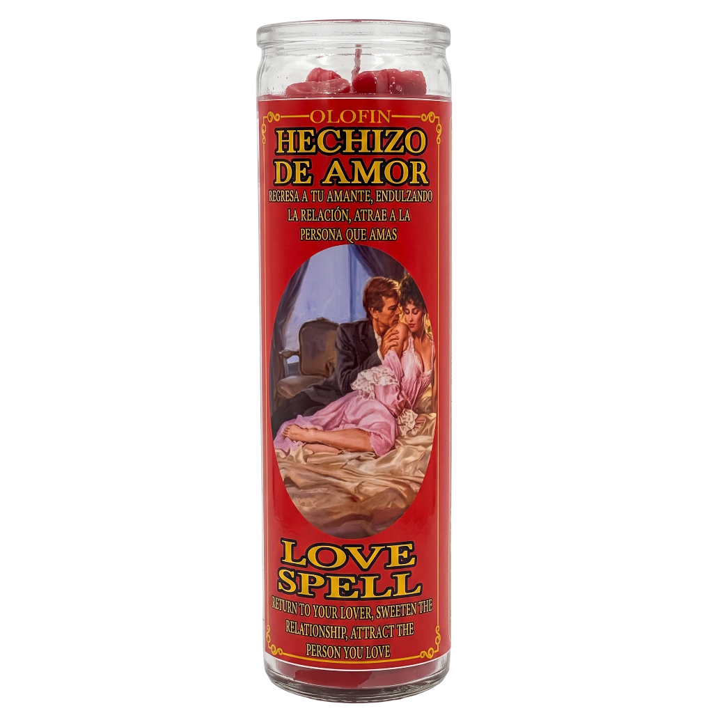 A tall glass jar candle labeled 'Olofin Hechizo de Amor Love Spell' with a red label, yellow and black text, and an illustration of a couple in bed. Red wax is visible at the top of the clear glass container.