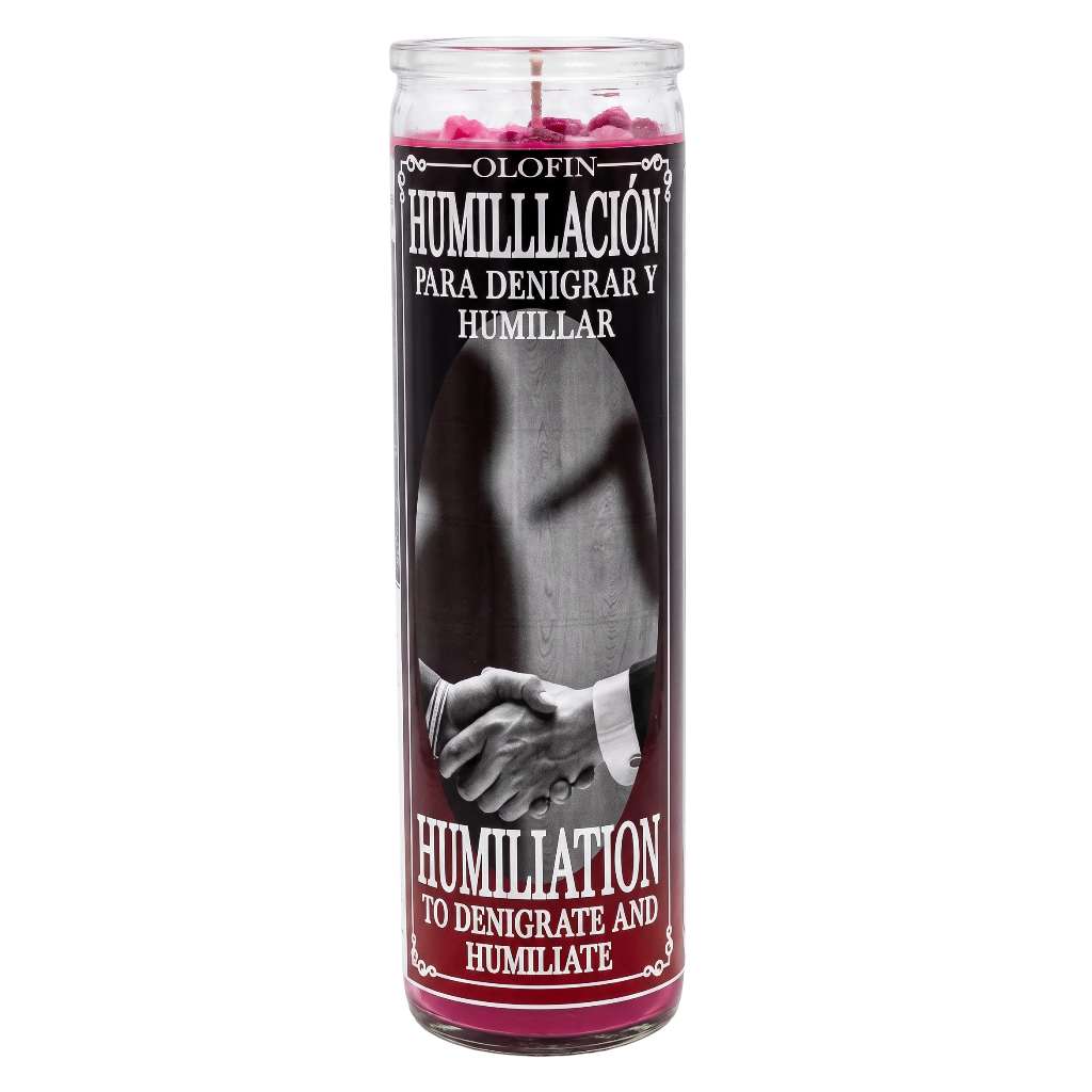 A tall glass jar candle with a black and white graphic label featuring a handshaking image, with pink wax visible at the top and red text reading 'Olofin Humillacion' and 'Humiliation to denigrate and humiliate'.