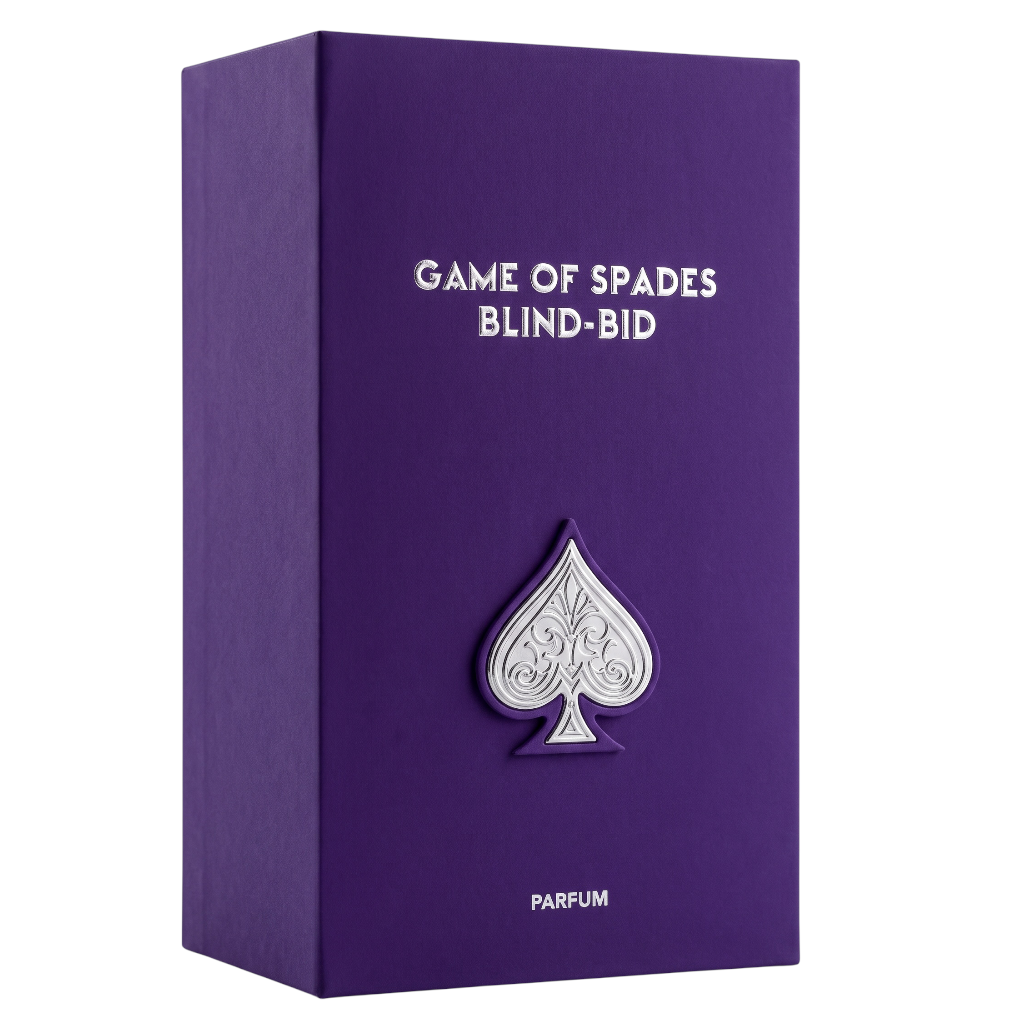 Purple rectangular box with white text reading 'GAME OF SPADES BLIND-BID' and 'PARFUM', featuring a raised silver spade emblem on the front, shown on a white background.