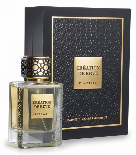 Perfume bottle and packaging with 'Creation de Reve' branding on a white background
