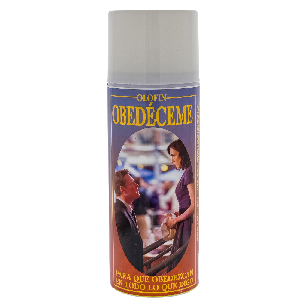 A single aerosol can of Olofin Obedecéme spray with a white cap and a purple label featuring a photo of a man and woman, on a plain white background.