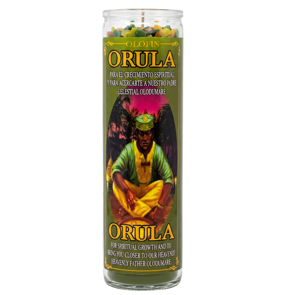 A tall glass prayer candle labeled 'ORULA' with a green label featuring an illustrated figure and multicolored wax pieces visible at the top, shown on a plain white background.