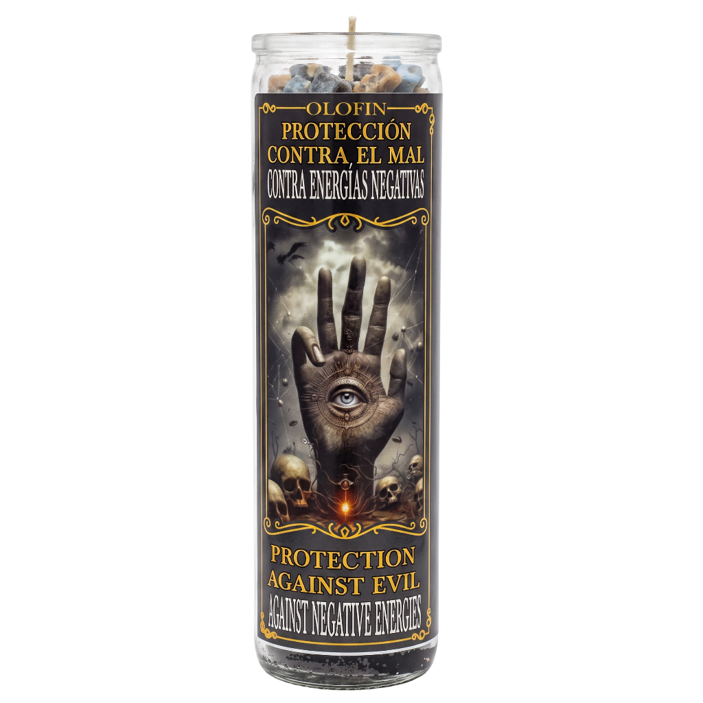 A tall glass jar candle with a black label featuring a hand with an eye, skulls, and Spanish and English text reading 'Protection against evil against negative energies'.