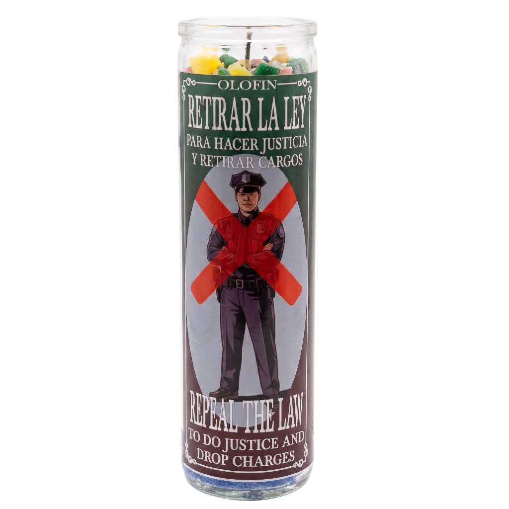A tall glass jar candle with a printed label reading 'Olofin Retirar La Ley' and 'Repel the Law,' featuring an illustration of a police officer crossed out with a red X, on a white background.