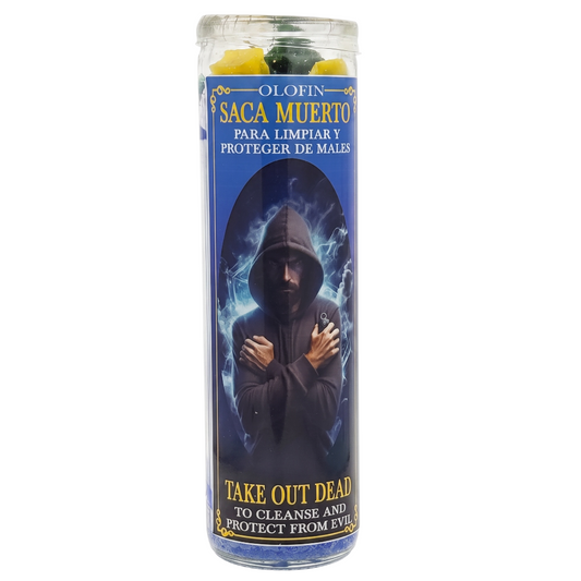 A tall glass jar candle labeled 'OLIN SAGA MUERTO' with a blue label showing a hooded figure and text including 'TAKE OUT DEAD TO CLEANSE AND PROTECT FROM EVIL'. Yellow and green wax pieces are visible at the top.
