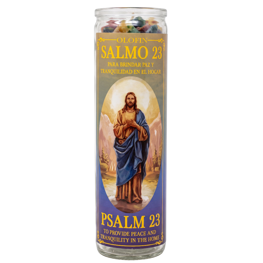 A tall glass prayer candle with a printed label featuring Jesus in blue and brown robes, with Spanish and English text reading 'Salmo 23' and 'Psalm 23'.
