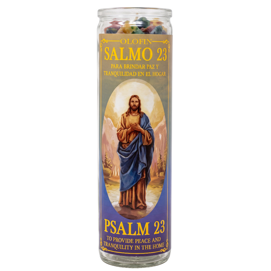 A tall glass prayer candle with a printed label featuring Jesus in blue and brown robes, with Spanish and English text reading 'Salmo 23' and 'Psalm 23'.