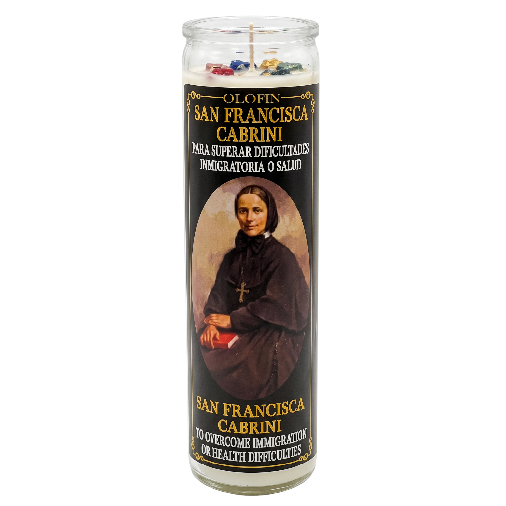 A tall glass jar prayer candle with a black label featuring a portrait of Saint Francis of Assisi and Portuguese and English text reading 'O Infierno San Francisco Cabrini' and 'No overcome immigration or health difficulties.'.