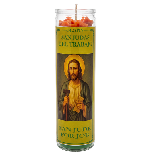 A tall glass prayer candle with a yellow label featuring an illustration of Saint Jude Thaddeus. The top of the candle has orange wax pieces visible, and the label reads 'OLIN SAN JUDAS DEL TRABAJO' and 'SAN JUDE FOR JOB' in Spanish and English.