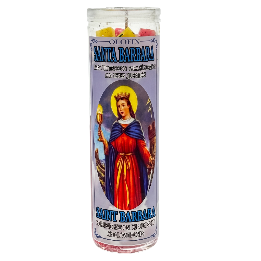 A tall glass devotional candle with a Santa Barbara religious label, containing multicolored wax pieces visible at the top, shown on a plain white background.