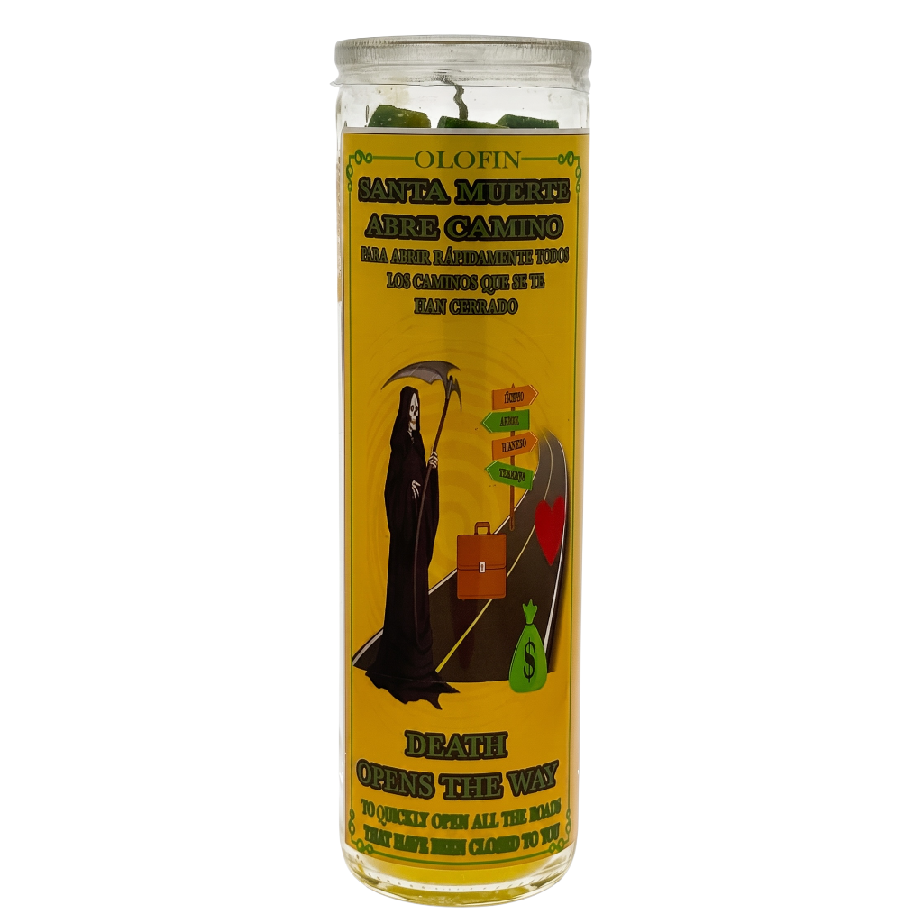 A tall glass jar candle with a yellow label featuring Santa Muerte artwork and Spanish text, photographed on a plain white background.