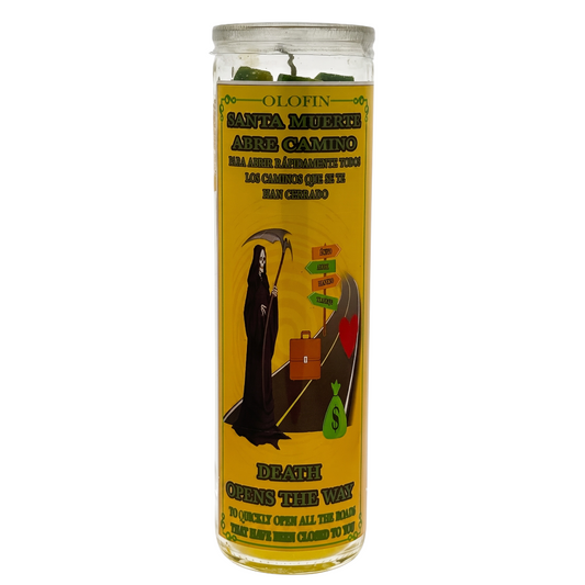 A tall glass jar candle with a yellow label featuring Santa Muerte artwork and Spanish text, photographed on a plain white background.