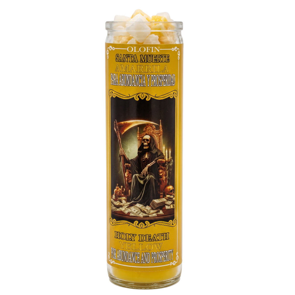A tall glass jar candle with a yellow and black label featuring Santa Muerte artwork, topped with white popcorn pieces, on a plain white background.