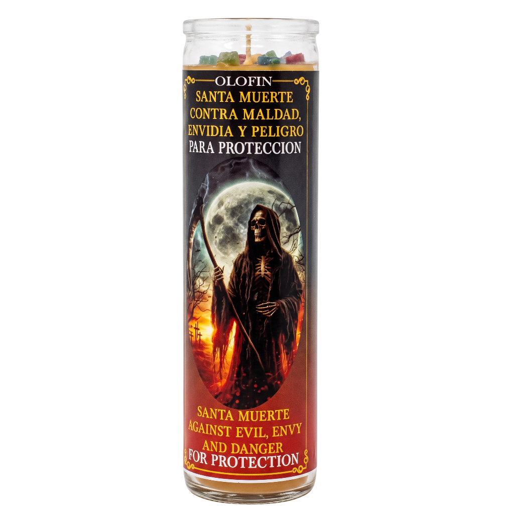 A tall glass jar candle with a Santa Muerte graphic label, featuring Spanish and English text for protection against evil, envy, and danger.