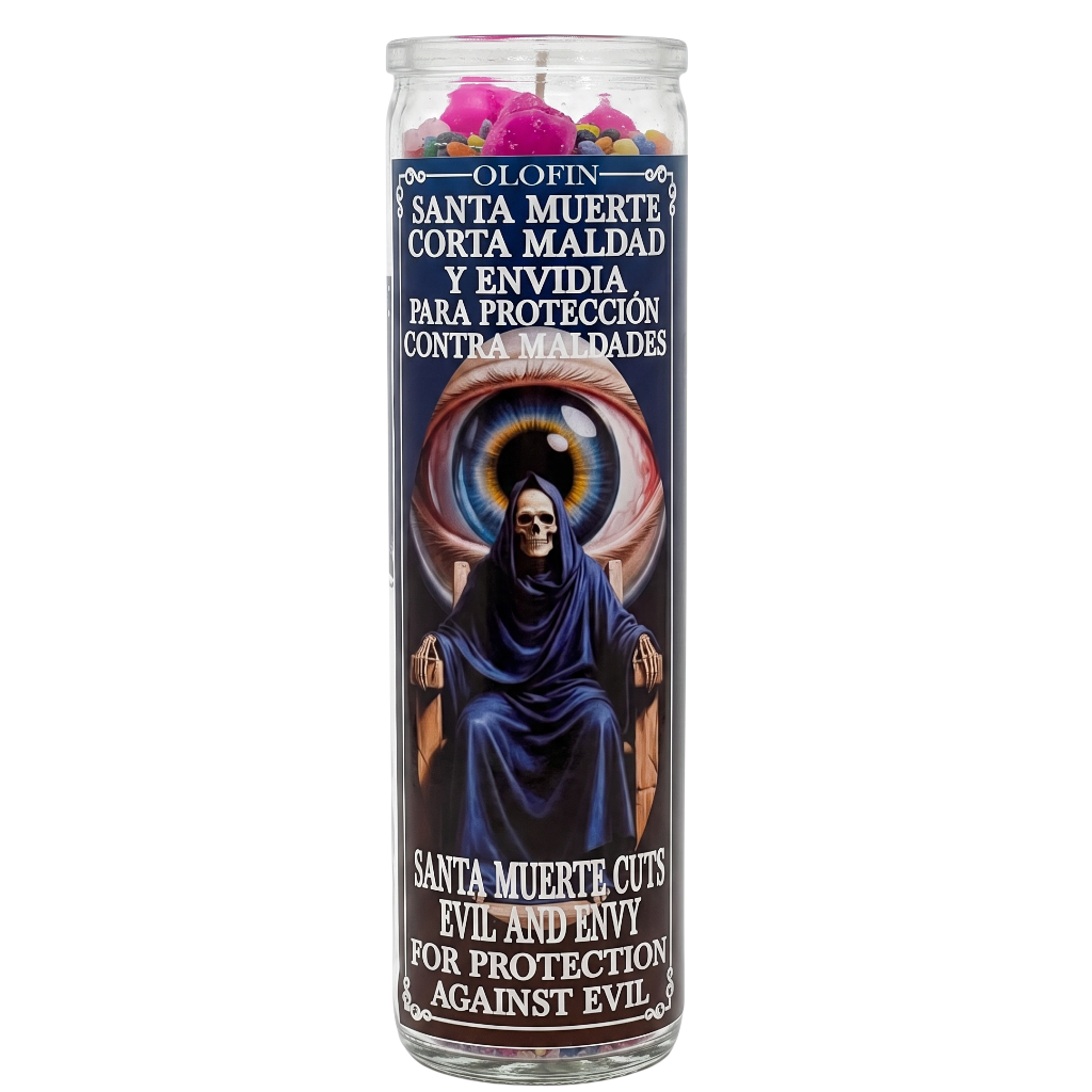 A tall glass jar prayer candle with a Santa Muerte religious label, featuring a dark blue and black design with white text and a pink flower arrangement at the top, shown on a plain white background.
