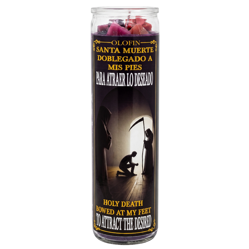A tall glass jar candle with a black label featuring Spanish and English text, silhouettes of cloaked figures, and pink rose petals visible at the top on a white background.