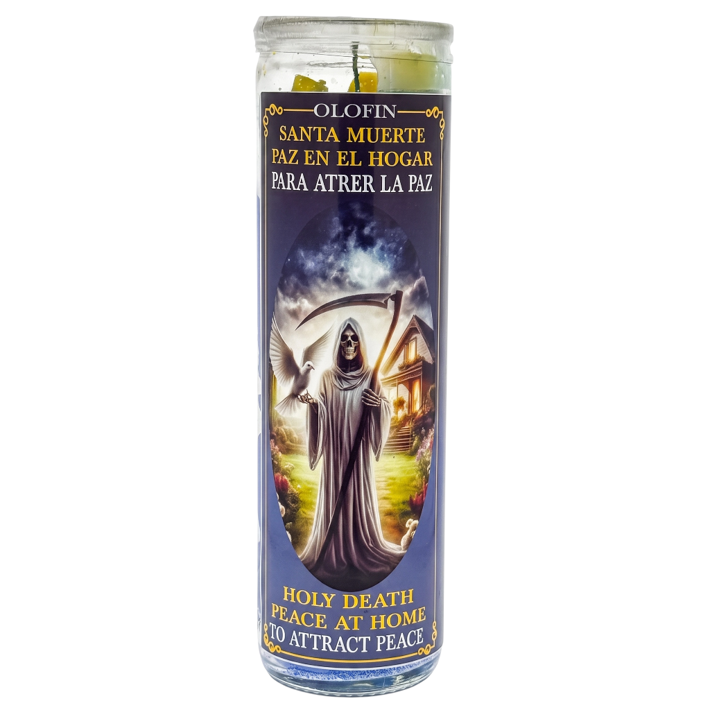 A tall glass prayer candle with a printed devotional label showing Santa Muerte in a gray robe holding a scythe, with Spanish and English text including 'Olorin' and 'Holy Death Peace at Home'.