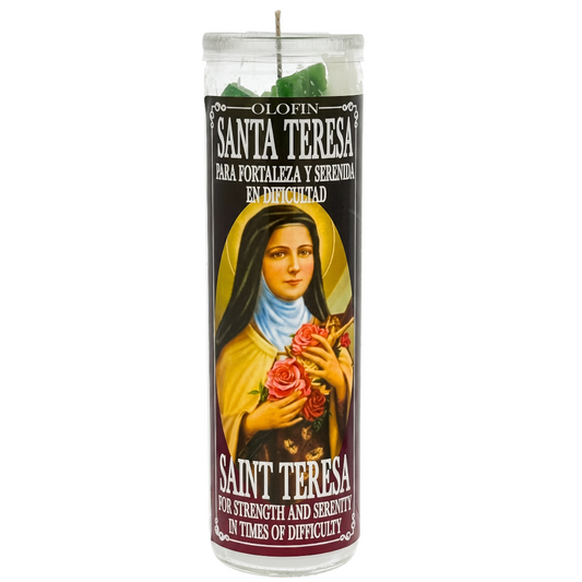 A tall glass jar candle with a printed devotional label featuring Saint Teresa, shown on a plain white background. The candle wax at the top appears green, and the label text includes 'Santa Teresa' and 'Saint Teresa' with Spanish and English wording about strength and serenity in times of difficulty.