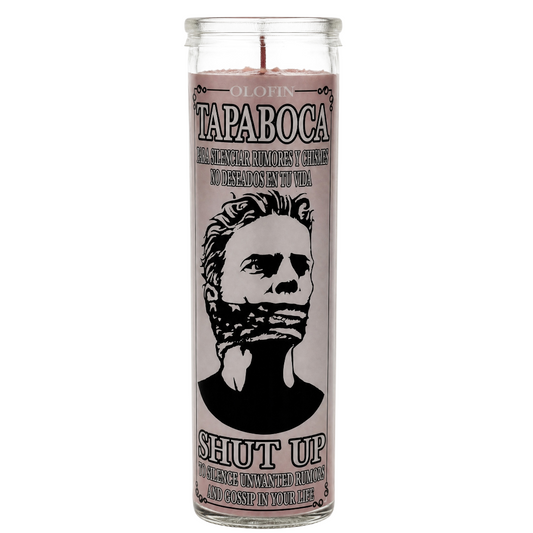 A tall glass jar candle with a pale pink label featuring a black-and-white illustrated portrait and the text 'OLAFIN TAPABOCA' and 'SHUT UP'.