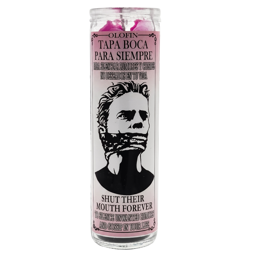 A tall glass jar candle with a white label featuring a black illustrated portrait of a gagged face and Spanish text reading 'Olofin Tapa Boca Para Siempre' and 'Shut Their Mouth Forever.' The candle wax at the top is pink, and the label border is light pink.