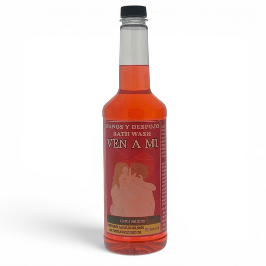 A bottle of Ven A Mi bath wash with a red label and orange-red liquid inside, shown on a plain white background.